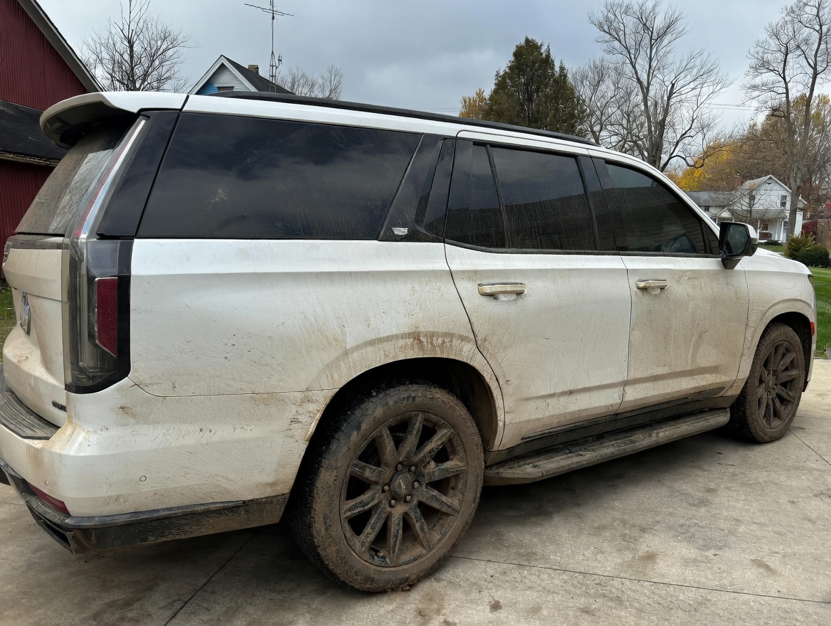 White Cadillac Escalade before detail — mud and road grime