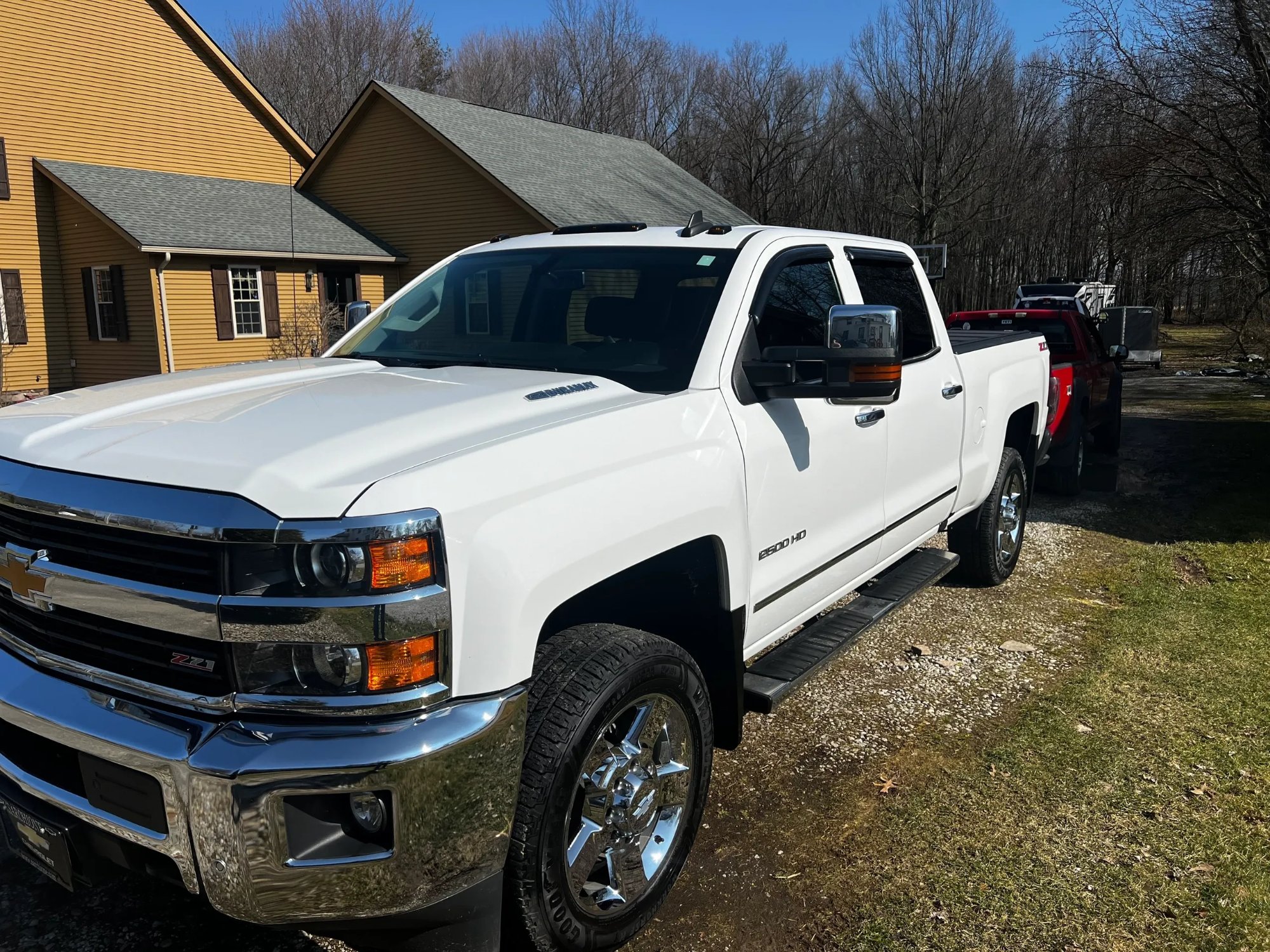 Chevy Silverado 2500HD after ceramic coating — glossy white finish and chrome wheels